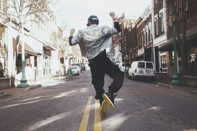 Man jumping in the middle of the road